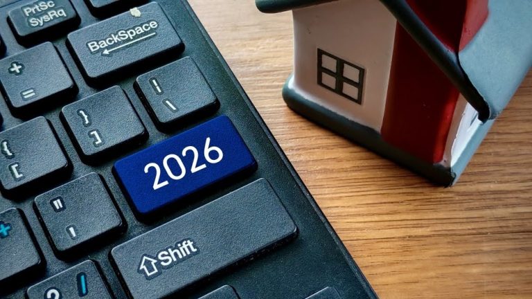 2026 button on a laptop with a small model home next to it on a desktop