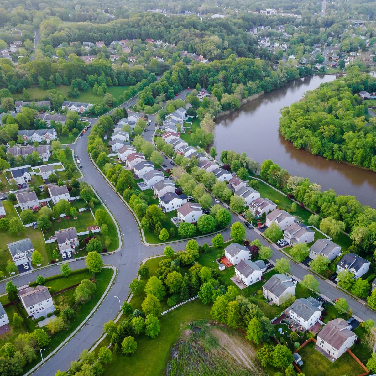 Aerial view of a riverside residential neighborhood